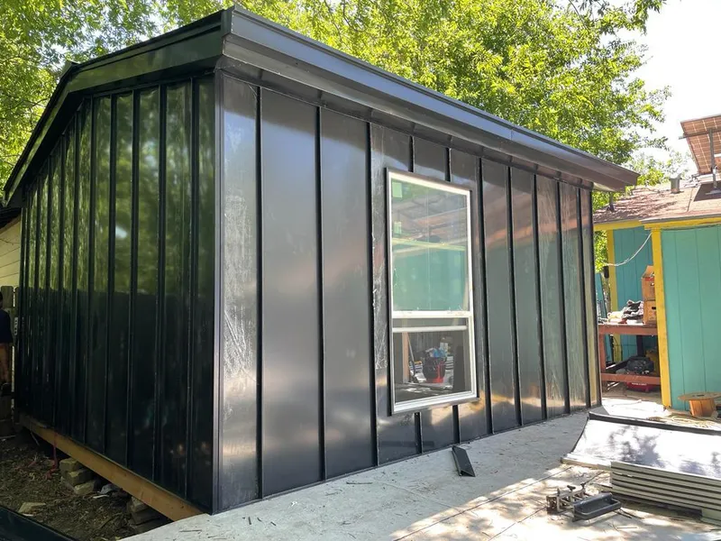 Black standing seam metal wall panels for Roof Inspection in Granby